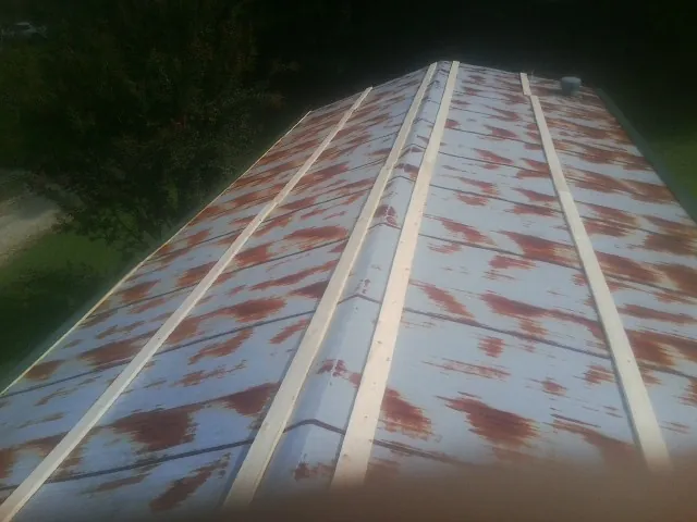 Rusted metal roof panels with new wood purlins before replacement — Storm Damage Roof Repair in Westernville by Roofing Brothers