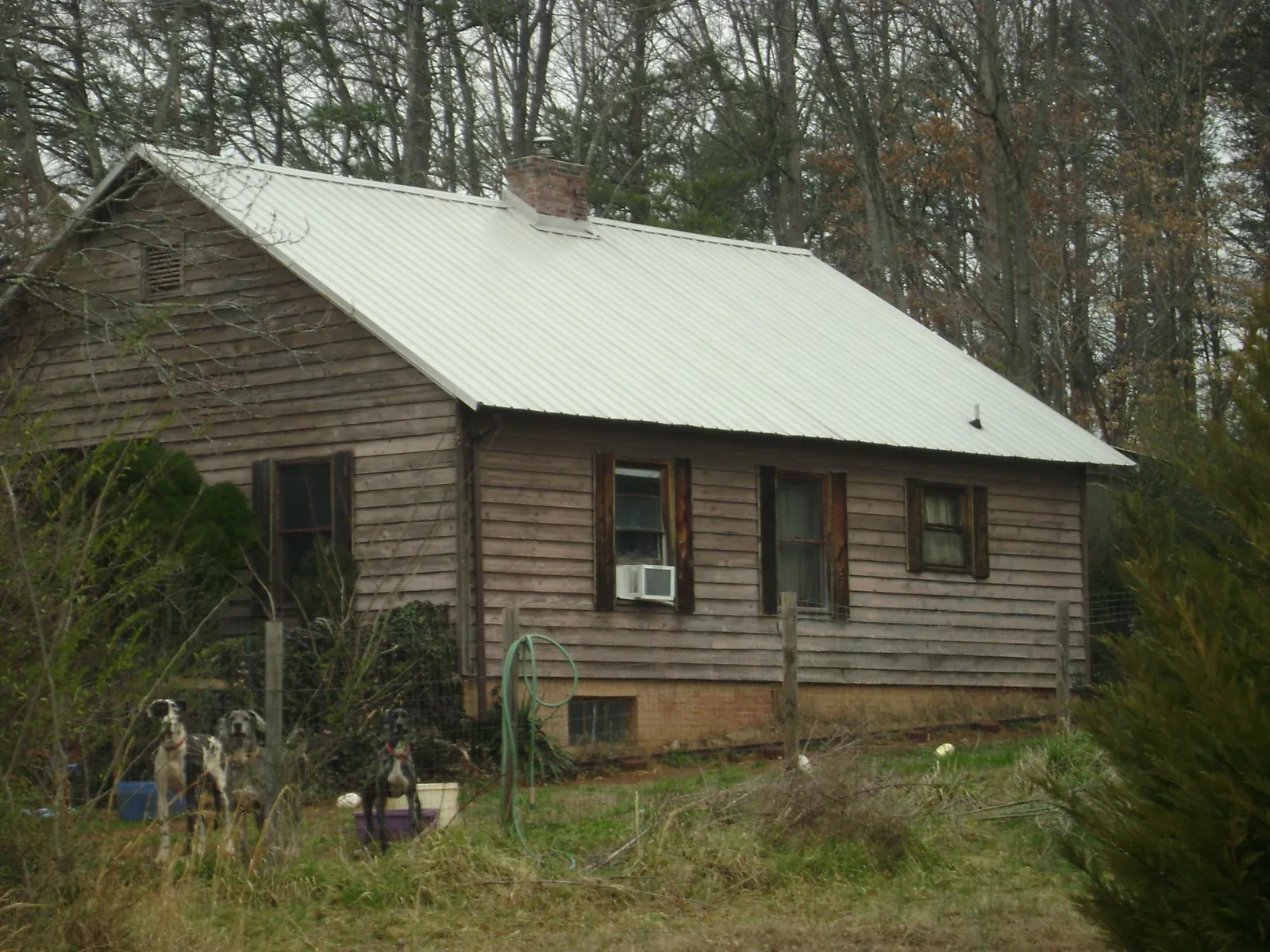 White metal roof on an old wood sided farmhouse, from a Metal Roof Installation job in Westernville